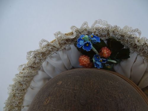 Detail view of the lace and flowers that trim the inside of the brim.